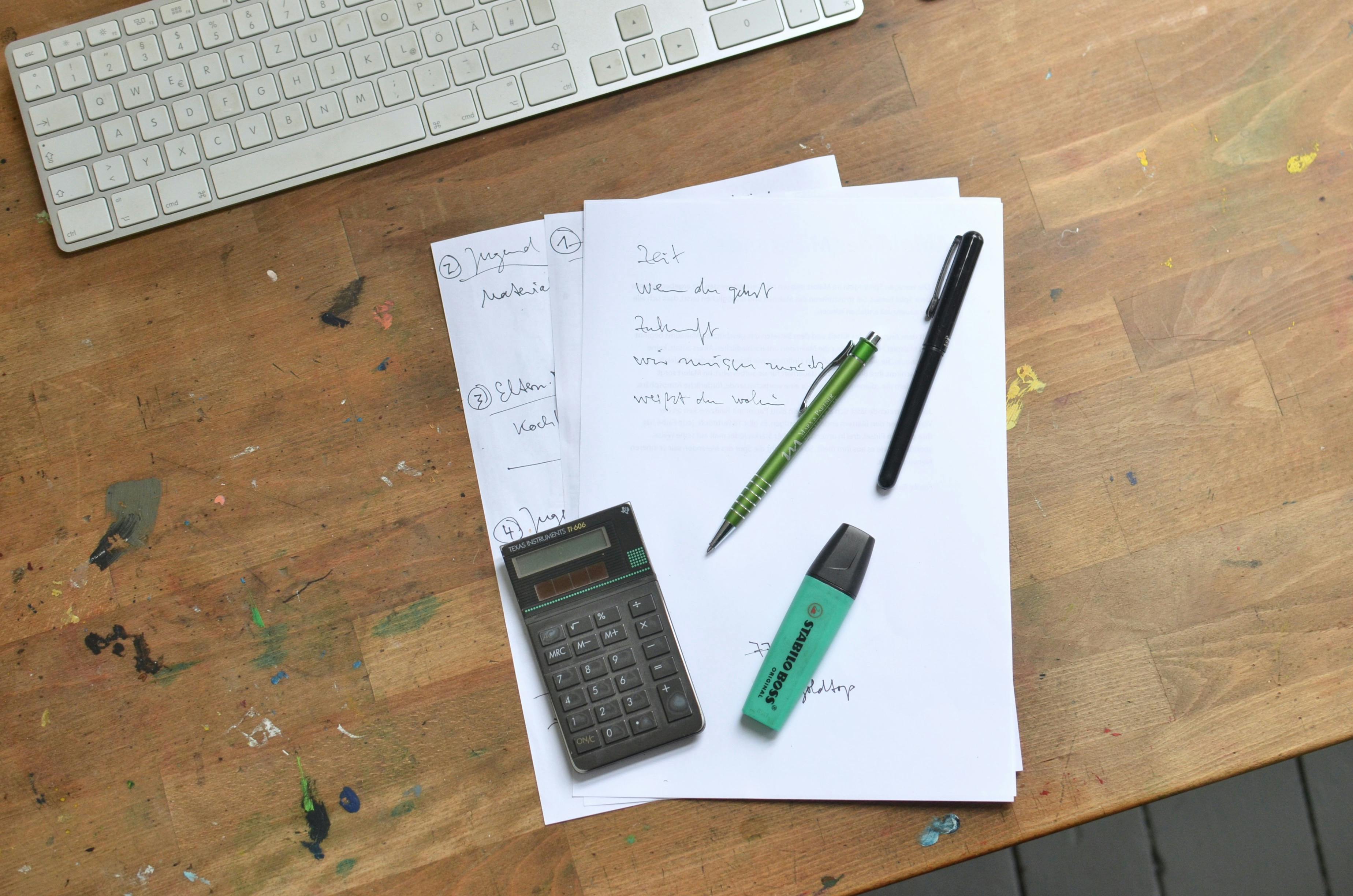 Calculator and paperwork used for reviewing a solar quote